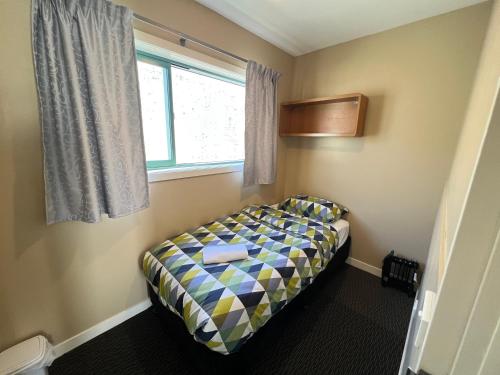 A bed or beds in a room at Stay Hostel Rotorua