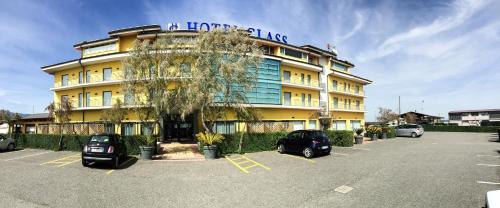 a large building with cars parked in a parking lot at Best Western Hotel Class Lamezia in Lamezia Terme