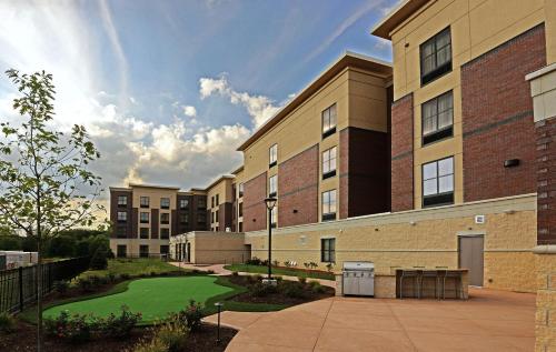 a building with a golf course in front of it at Homewood Suites by Hilton Cincinnati/Mason in Mason