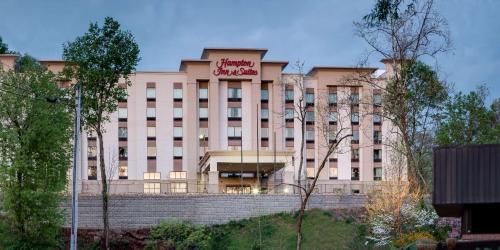 a large pink building with a sign on it at Hampton Inn & Suites - Knoxville Papermill Drive, TN in Knoxville