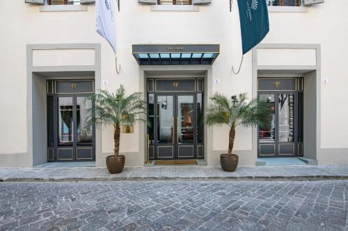 two palm trees in front of a building at Hotel La Gemma in Florence