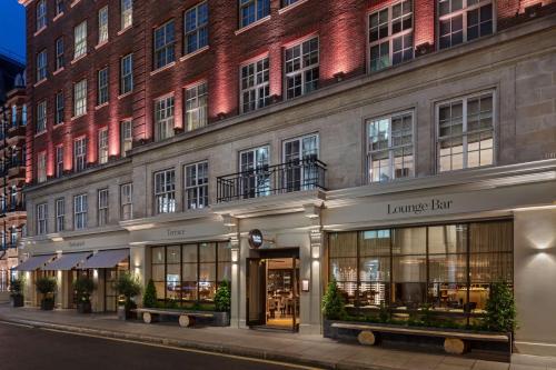 a facade of a building with a large brick building at The May Fair, A Radisson Collection Hotel, Mayfair London in London