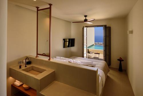 a bathroom with a sink and a bed and a mirror at Elessa Hotel in Pyrgos