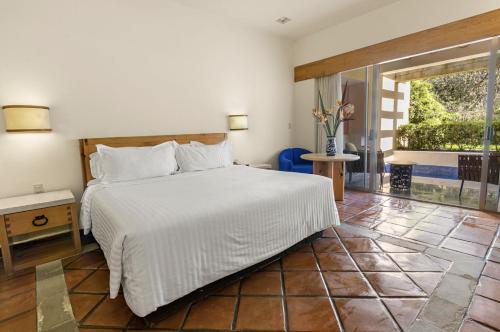 Cama ou camas em um quarto em Hotel Rancho San Diego Grand Spa Resort