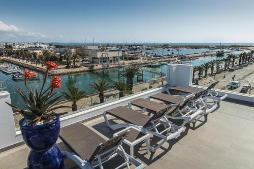 a balcony with chairs and a view of a marina at Hotel Marina Rio in Lagos