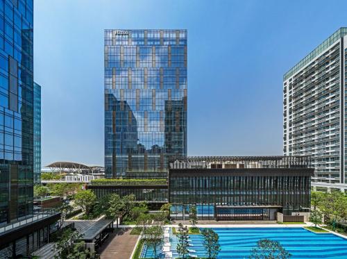 a view of a building with a pool in front of it at Hilton Shenzhen World Exhibition & Convention Center - Only 5 minutes' walk to WECC in Shenzhen