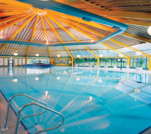 a large swimming pool with a large roof at The Gleneagle Hotel & Apartments in Killarney