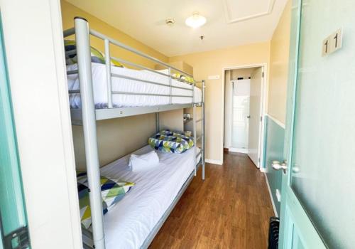 A bed or beds in a room at Stay Hostel Rotorua