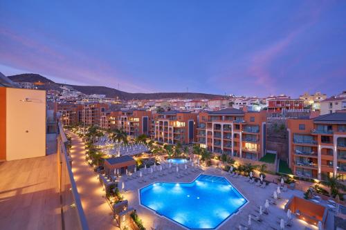 a view of a city with a swimming pool at night at Arguineguín Park By Servatur in La Playa de Arguineguín