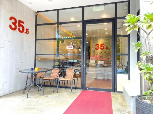 a table and chairs in front of a store at 35.5 Inn in Kenting