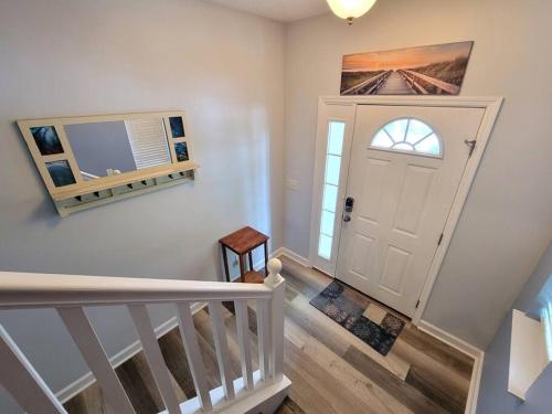 a hallway with a white door and a stairway at McDrifty's Getaway in Panama City Beach