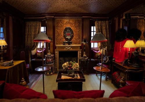 a living room with a fireplace and two lamps at The Witchery by the Castle in Edinburgh