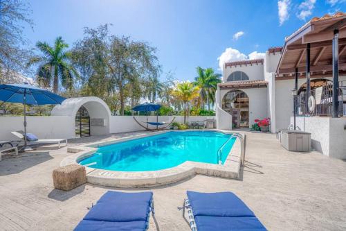 a swimming pool in a yard next to a house at Villa at St James Unit A Luxury Pool Villa, Pet Friendly in Miami