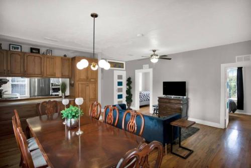 a dining room and living room with a table and a couch at 1940 cottage seen on FYI, 2bd 2ba in Gainesville