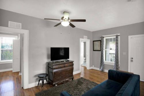 a living room with a couch and a ceiling fan at 1940 cottage seen on FYI, 2bd 2ba in Gainesville