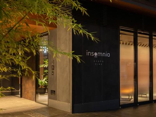 a facade of a building with glass doors at insomnia KYOTO OIKE in Kyoto