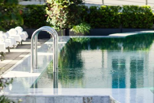 a swimming pool with a faucet in the middle of a pool at Four Seasons Hotel Buenos Aires in Buenos Aires