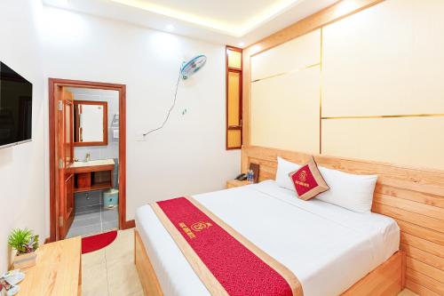 - une chambre avec un lit et une télévision dans l'établissement Ngọc Sang 1 Hotel, à Đà Lạt