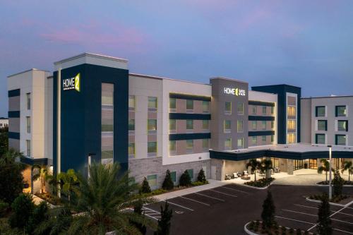 a hotel with a parking lot in front of it at Home2 Suites Orlando Southeast Nona in Orlando