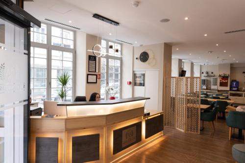 a restaurant with a bar and a dining room at Hotel Saint Augustin in Strasbourg