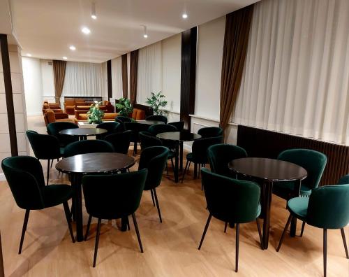 a row of tables and chairs in a room at Hotel Meranda in Camigliatello Silano