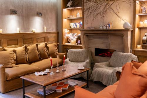 a living room with a couch and a fireplace at Hotel Beaucour in Strasbourg