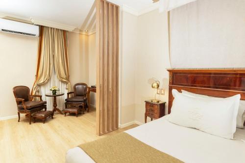 a hotel room with a bed and a desk and chairs at Melia Recoleta Plaza Hotel in Buenos Aires