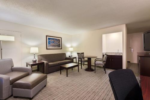 a living room with a couch and a table at Holiday Inn Knoxville West - Cedar Bluff, an IHG Hotel in Knoxville