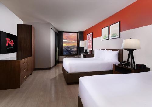 a hotel room with two beds and a large window at Plaza Hotel & Casino in Las Vegas