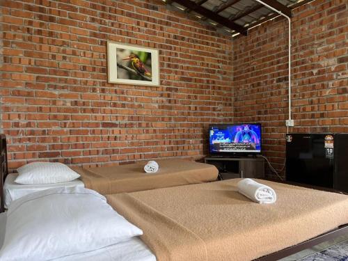 A bed or beds in a room at MyDusun Chalet, Taiping, Perak, Malaysia