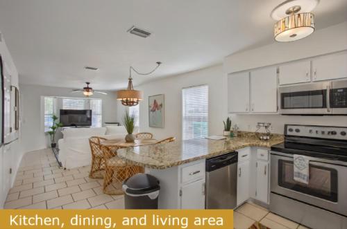 a kitchen with a dining room and living area at Estrella del Mar in Panama City Beach