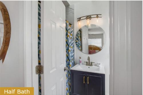 a bathroom with a sink and a mirror at Estrella del Mar in Panama City Beach