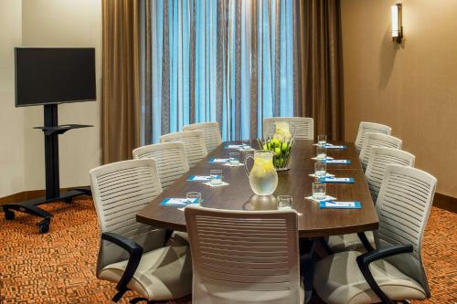 a conference room with a long table and white chairs at Hyatt House Seattle Downtown in Seattle