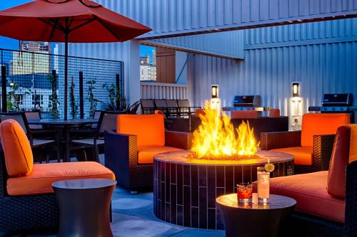 a fire pit on a patio with chairs and tables at Hyatt House Seattle Downtown in Seattle