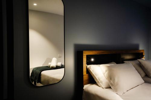 a mirror in a hotel room with a bed at Haka House Lake Tekapo in Lake Tekapo