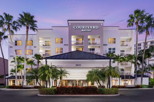 una rappresentazione di un hotel con palme di fronte di Courtyard by Marriott Miami Aventura Mall ad Aventura