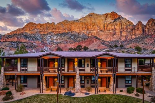 aominium building with a mountain in the background at The Red Cliffs Lodge Zion, a Tribute Portfolio Hotel in Springdale