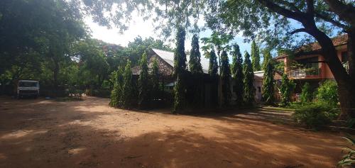 un patio de tierra con una casa y algunos árboles en PRIMESHADE GUESTHOUSE, en Malindi