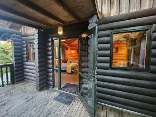 a room with a door leading to a bedroom at Rainforest Retreat in Franz Josef