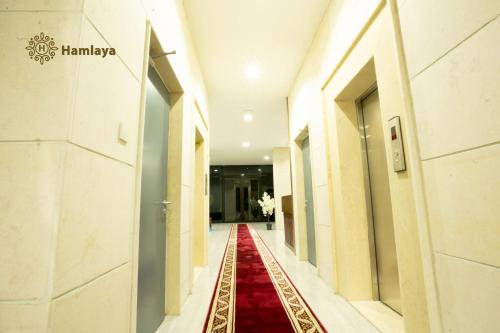 korytarz z czerwonym dywanem w budynku w obiekcie hamlaya apartments هملايا للشقق الفندقيها لفروانيه w Kuwejcie