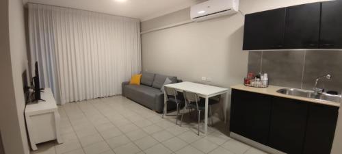 a kitchen with a couch and a table and a sink at Mediterranean Sea View in Ashqelon