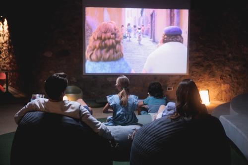 a group of people sitting in front of a tv at Mandarin Oriental, Costa Navarino in Pylos