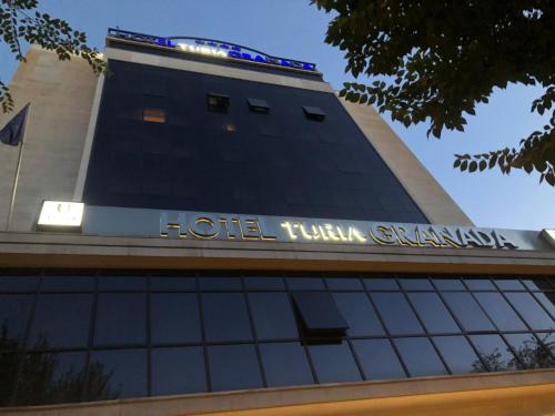 a hotel sign on the top of a building at Turia Granada in Granada