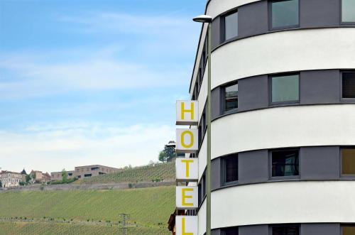 a hotel with the word hotel on the side of a building at B&B HOTEL Offenburg-Hbf in Offenburg