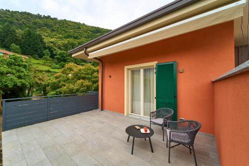 a patio with two chairs and a table at Hotel Villa Cuserina in Cannobio