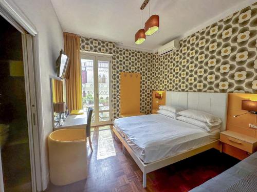 a bedroom with a bed in a room with a wall at B&B Pellicano Guest House in Reggio di Calabria