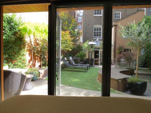 a view of a patio through a window at Romantic Bungalow in Notting Hill in London