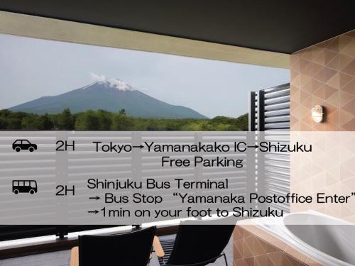 a view of a mountain through a window at Mt Fuji View and Private Sauna Ryokan Shizuku in Yamanakako