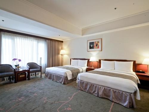 Кровать или кровати в номере The Howard Prince Hotel Taichung