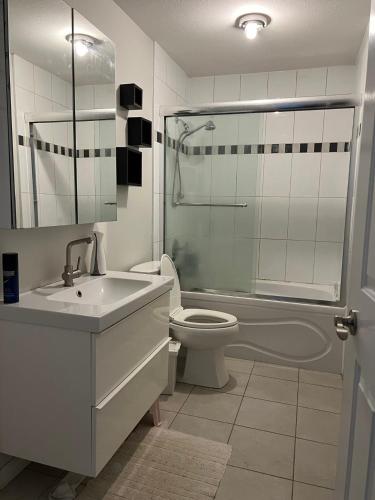 a bathroom with a sink and a toilet and a shower at Vancouver Airport Cozy room 舒适小屋, Richmond,near YVR in Richmond